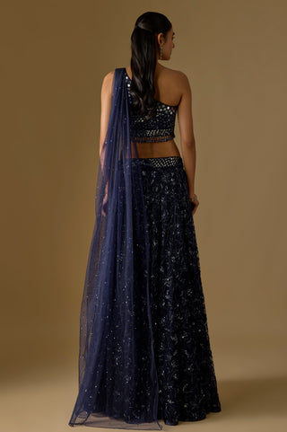 Back view of the navy net drape falling from one shoulder over the sequin embroidered flared skirt by Asaga at Mrs. G