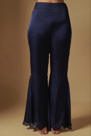 Waist-down view of navy flared satin sharara with godets at the hem by Asaga at Mrs. G