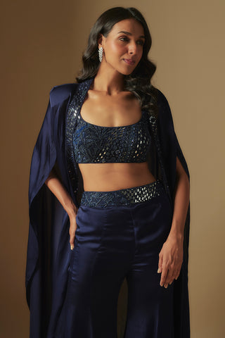 Waist-up close-up of navy square-neck mirror blouse and embellished cape edge by Asaga at Mrs. G