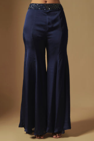 Waist-down view of navy flared satin sharara with a mirror-embroidered waistband by Asaga at Mrs. G