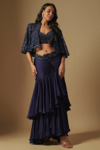 Front view of a navy mirror work blouse and sequin cape over a tiered satin ruffle skirt by Asaga at Mrs. G
