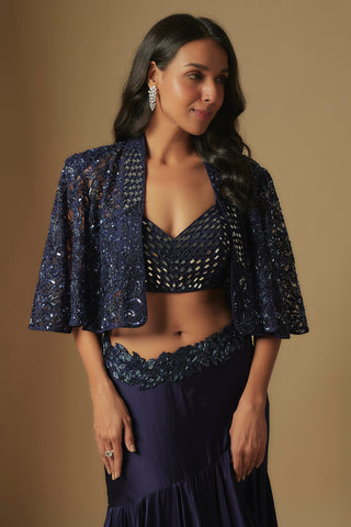 Waist-up view of the navy V-neck mirror work blouse and sequin embroidered bell-sleeve cape by Asaga at Mrs. G