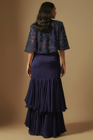 Back view of the navy cape and tiered satin ruffle skirt with a smooth fitted yoke by Asaga at Mrs. G