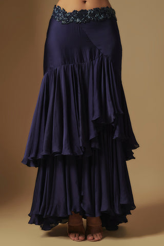 Waist-down view of the navy ruffle skirt with an embroidered scalloped waistband and dipped hem by Asaga at Mrs. G