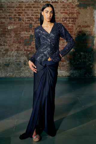 Front view of the navy blue jacket and drape skirt with the side slit showing by Asaga at Mrs. G