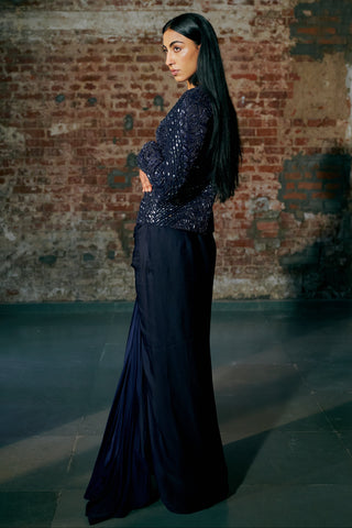 Side view of the navy blue sequin jacket sleeve and the drape skirt falling to the floor by Asaga at Mrs. G