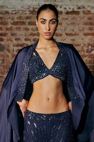 Waist-up view of the navy blue mirror blouse under the satin cape with the sequin sharara waistband by Asaga at Mrs. G