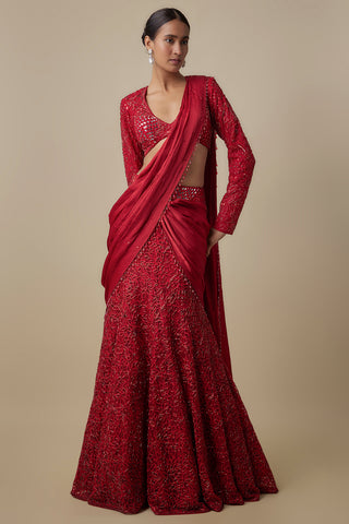 Full-length front view of the red pre-draped saree with a flared embroidered skirt and a full-sleeve blouse by Asaga at Mrs. G