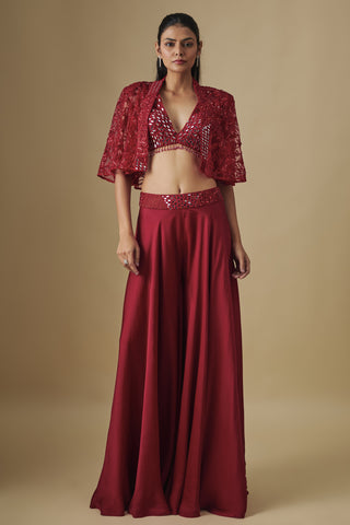 Front view of a red sharara set with a mirror V-neck blouse and a short embroidered net cape by Asaga at Mrs. G