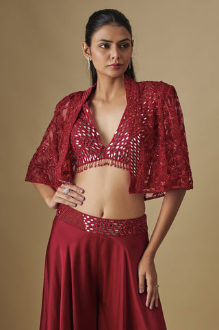 Waist-up view of the red mirror blouse with a bead fringe under a net cape with flared sleeves by Asaga at Mrs. G
