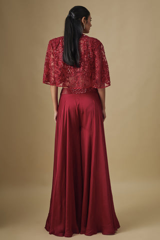 Back view of the red embroidered net cape and wide flared satin sharara by Asaga at Mrs. G