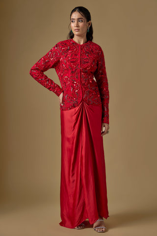 Full-length front view of the red sequin paisley jacket over a knotted satin organza drape skirt by Asaga at Mrs. G