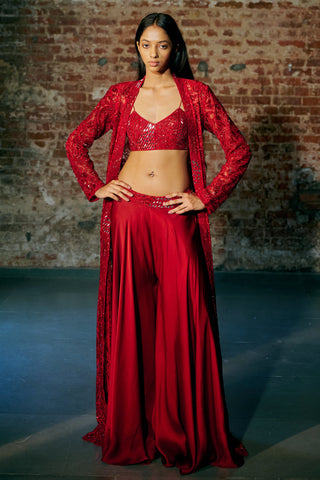 Front view of the red long jacket worn open over a sequin blouse and flared satin organza sharara by Asaga at Mrs. G