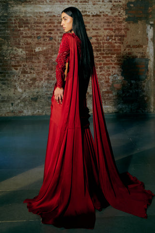 Back view of the red pre-draped saree with the pallu falling over the shoulder and trailing by Asaga at Mrs. G