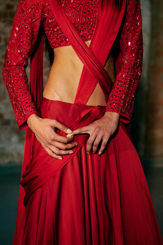 Close-up of the red mirror and sequin blouse sleeves and the draped pallu crossing the waist by Asaga at Mrs. G