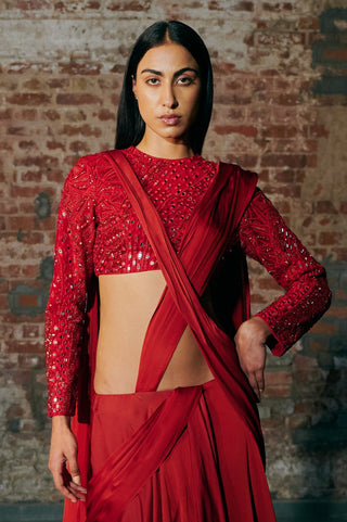 Waist-up view of the red drupe pre-draped saree and mirror work blouse set showing the mirror work blouse and the saree drape by Asaga at Mrs. G