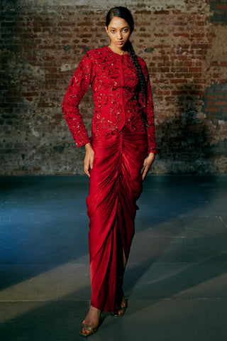 Front view of the red paisley-embroidered jacket with the ruched satin organza drape skirt and side slit by Asaga at Mrs. G