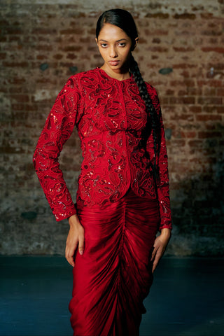 Waist-up view of the red round-neck jacket with paisley cord embroidery and sequins by Asaga at Mrs. G