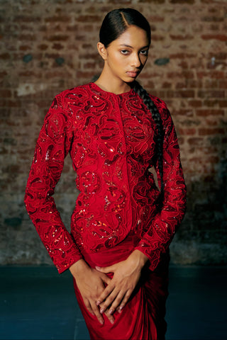 Side view of the red fitted jacket and the gathered waist of the drape skirt by Asaga at Mrs. G