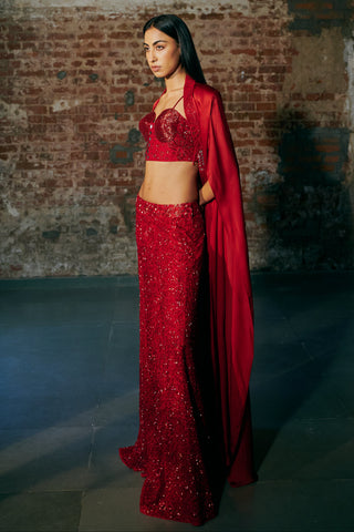 Three-quarter view of the red set with the long satin cape falling along one side by Asaga at Mrs. G