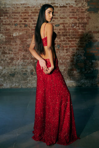 Back view of the red corset and sequin-embroidered sharara as the model looks over her shoulder by Asaga at Mrs. G
