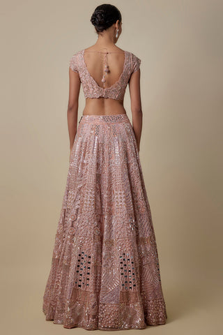 Full-length back view of the rose gold scooped-back blouse with a tie over the patchwork lehenga by Asaga at Mrs. G