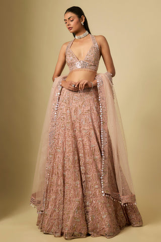 Full-length front view of the rose gold lehenga set with a halter blouse and a mirror-edged net dupatta by Asaga at Mrs. G