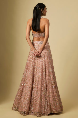 Full-length back view of the rose gold halter blouse with an open back over the paisley lehenga by Asaga at Mrs. G
