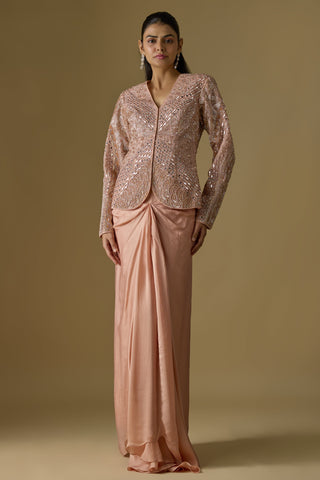 Full-length front view of a rose gold embroidered button-front jacket over a knot-drape satin organza skirt by Asaga at Mrs. G
