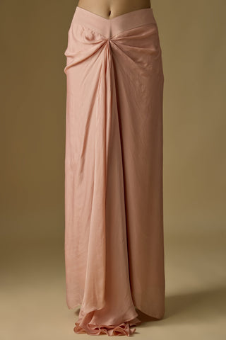Close-up of the rose gold draped satin organza skirt with a front knot and V-shaped waistband by Asaga at Mrs. G
