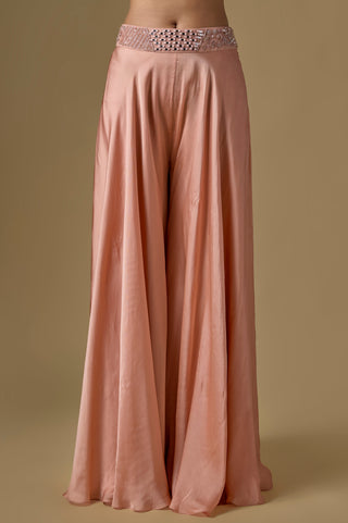 Detail of the rose gold wide-leg satin sharara and its mirror work waistband by Asaga at Mrs. G