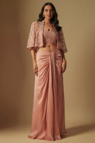 Front view of a rose gold embroidered square-neck blouse and net cape over a satin drape skirt by Asaga at Mrs. G