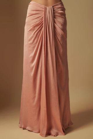 Waist-down view of the rose gold satin skirt with a gathered front drape by Asaga at Mrs. G