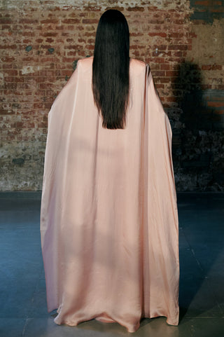 Back view of the rose gold long satin organza cape spread out behind the model by Asaga at Mrs. G