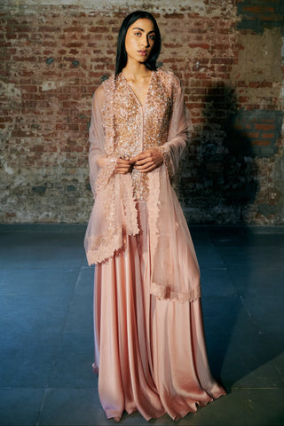 Front view of a rose gold cutdana jacket top with a satin sharara and a scalloped net dupatta by Asaga at Mrs. G