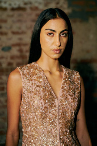 Waist-up view of the rose gold V-neck jacket top with copper and gold cutdana embroidery by Asaga at Mrs. G