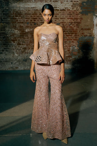 Front view of the rose gold strapless peplum with mirror trim and flared sequin sharara by Asaga at Mrs. G