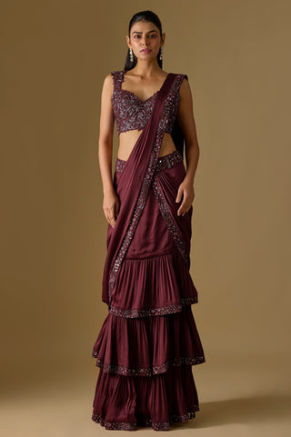 Full-length front view of the wine pre-draped saree with three ruffled tiers and a mirror work border by Asaga at Mrs. G