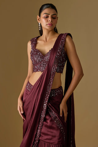 Waist-up view of the wine leaf appliqué blouse and the pallu crossing one shoulder over the draped front by Asaga at Mrs. G