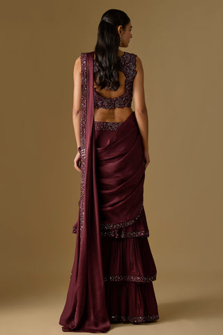 Back view of the wine blouse's keyhole cutout and the pallu falling over the ruffled tiers by Asaga at Mrs. G