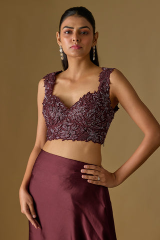 Close-up of the wine sweetheart blouse with raised leaf appliqué and sequins styled with a plain satin skirt by Asaga at Mrs. G