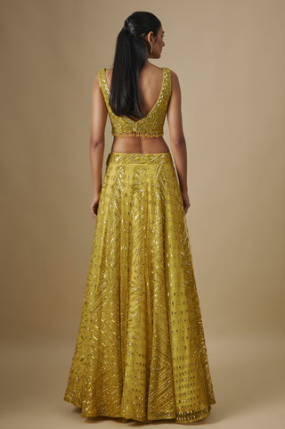 Back view of the yellow scooped-back blouse and flared sequin skirt by Asaga at Mrs. G