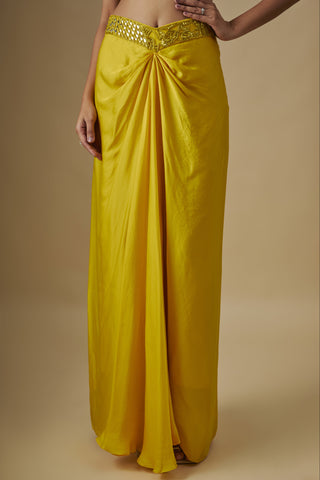 Close-up of the yellow knot-drape satin skirt with a mirror waistband by Asaga at Mrs. G