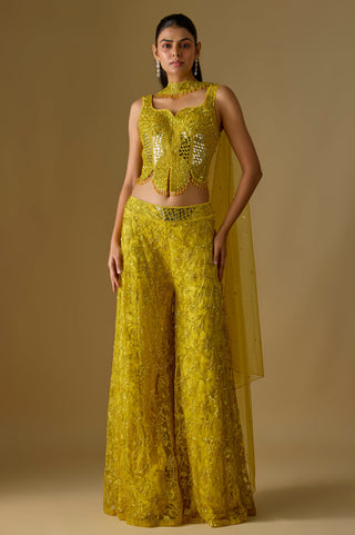 Full-length front view of the yellow corset with a mirror work center panel over a sequin embroidered sharara by Asaga at Mrs. G