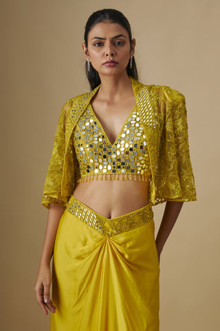 Waist-up view of the yellow round-mirror V-neck blouse under a net cape with flared sleeves by Asaga at Mrs. G