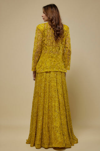 Back view of the yellow sheer jacket and vine embroidered flared skirt by Asaga at Mrs. G