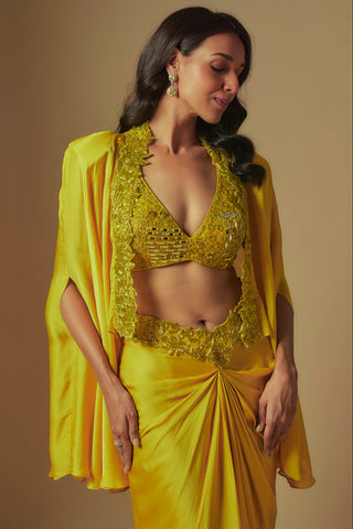 Waist-up close-up of yellow V-neck mirror blouse with floral cutwork border and cape by Asaga at Mrs. G