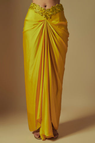 Waist-down view of yellow satin drape skirt knotted at the center with a cutwork waistband by Asaga at Mrs. G
