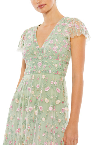 Close-up of the pink and cream flowers embroidered on the sage bodice and V-neckline by Mac Duggal at Mrs. G