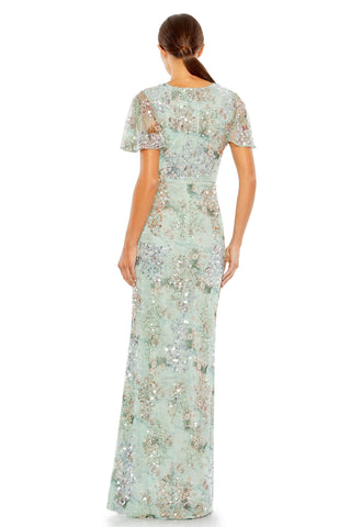 Back view of the green sequined mesh gown showing the round neckline and butterfly sleeves by Mac Duggal at Mrs. G